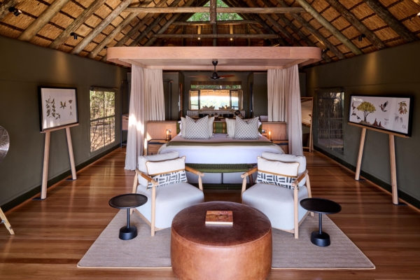 A luxury safari lodge suite with a four-poster bed