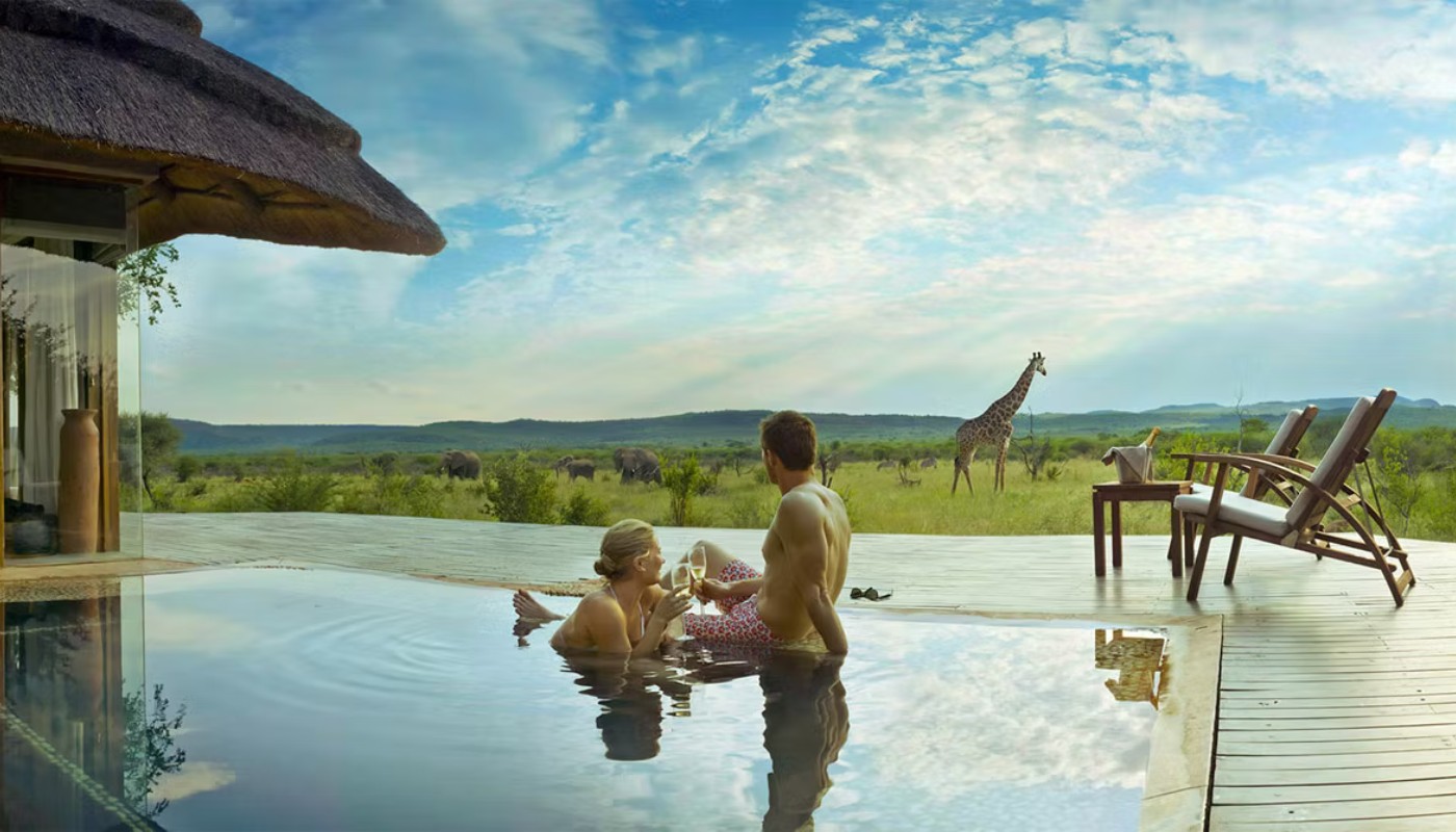 Couple on a luxury Africa honeymoon safari at sunset